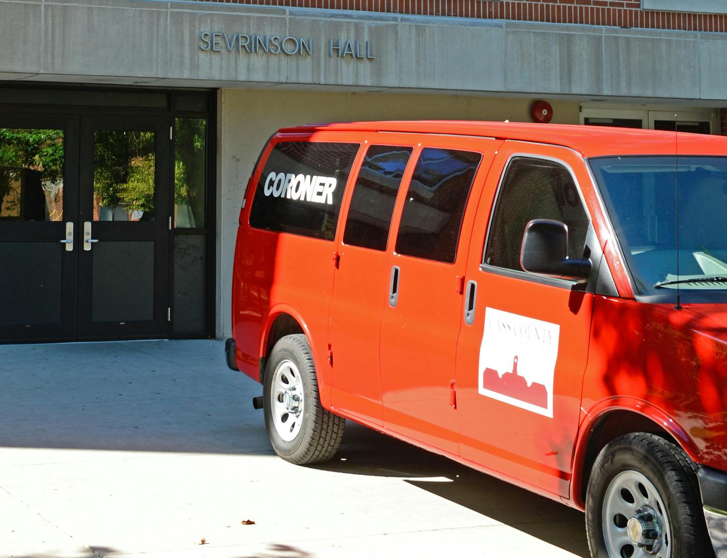 A Cass County coroner van sits in front of Sevrinson Hall on the North Dakota State University campus on Sunday, Sept. 17. A 17-year-old died at the residence hall. The victim is believed to be a high school student from a Minneapolis suburb. Blake Gumprecht / The Forum