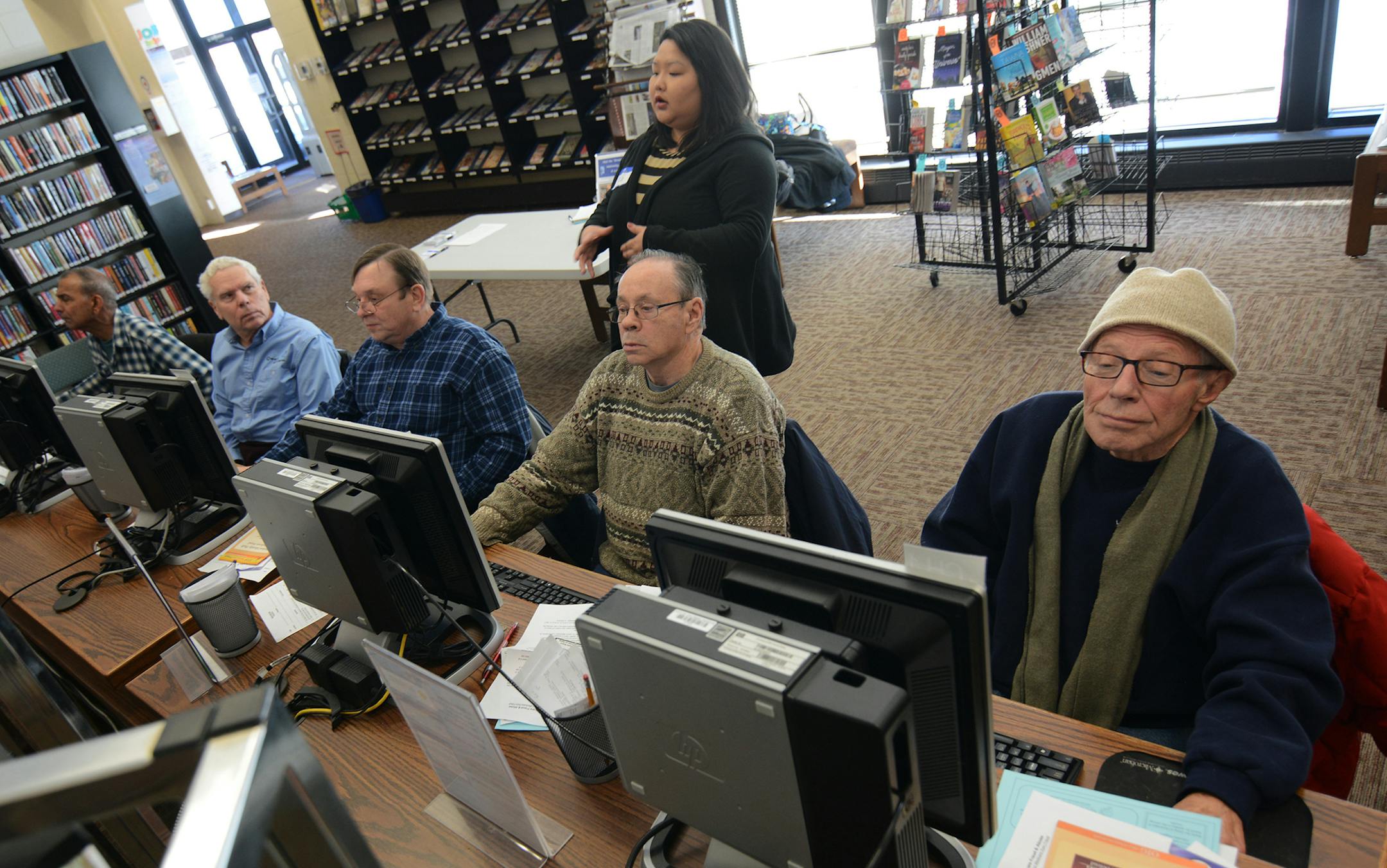 Instructor Chee Moua led students (left to right) Vishnu Isreepersaud (of Blaine), Joe Berzak (of Columbia Heights), Steve Kondrick (of Columbia Heights), Stephen Weselenak (of Minneapolis), and Elton Carlson (of Columbia Heights) in a class on surfing the web at Columbia Heights Public Library. Photo by Liz Rolfsmeier, Special to the Star Tribune