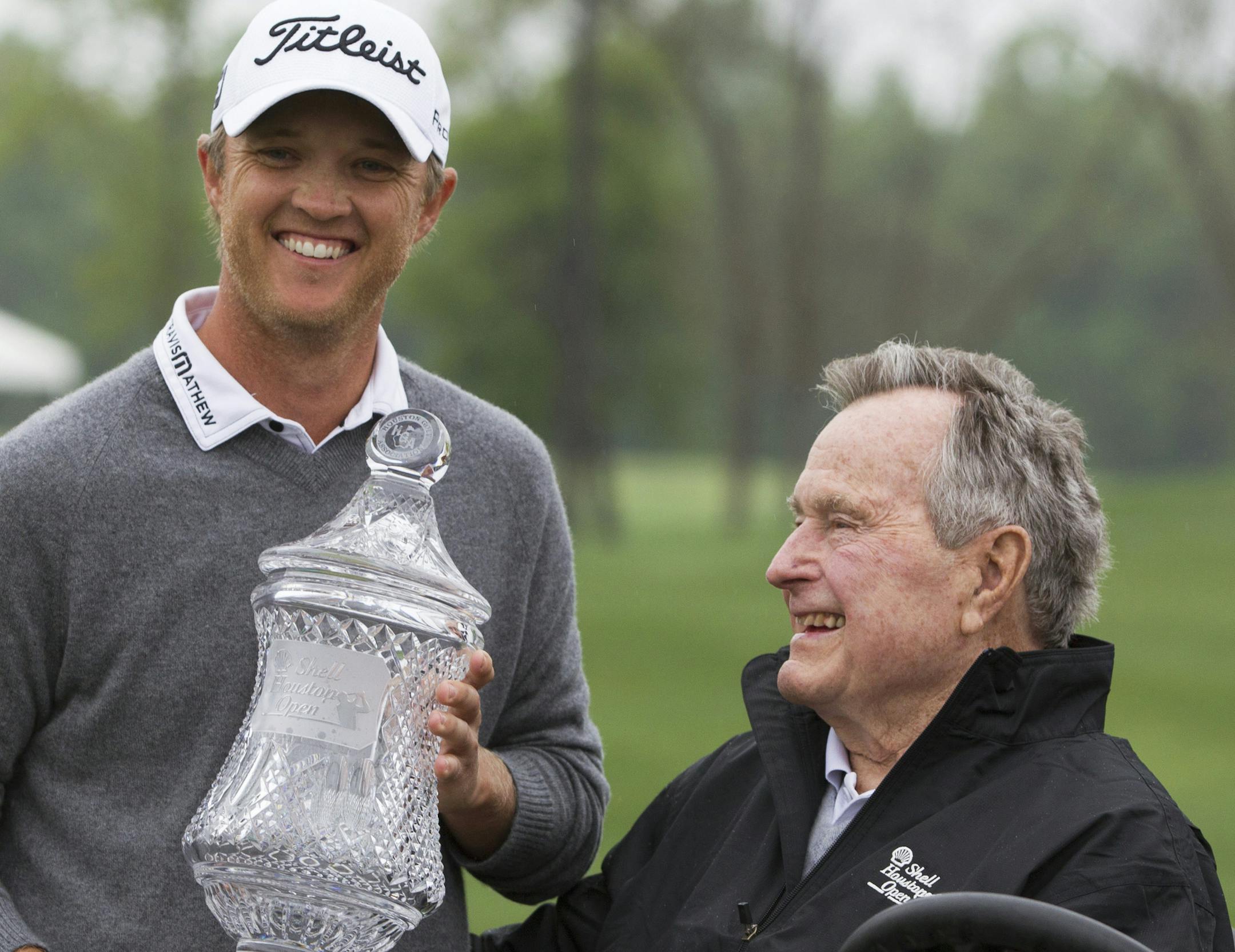 Matt Jones, left, poses for a photo with Former President George H.W. Bush after winning the Houston Open golf tournament, Sunday, April 6, 2014, in Humble, Texas. (AP Photo/Patric Schneider)