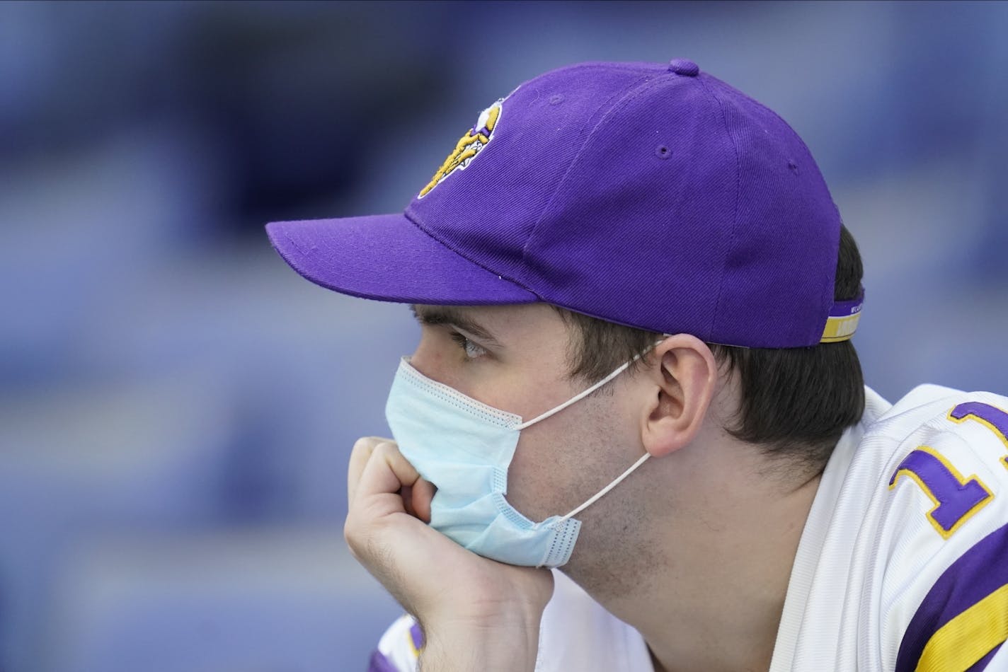 A Minnesota Vikings fan watches during the second half of an NFL football game between the Indianapolis Colts and the Minnesota Vikings, Sunday, Sept. 20, 2020, in Indianapolis.