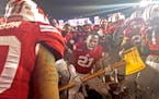 Wisconsin's cornerback Peniel Jean (21) took Paul Bunyan's Axe to the visiting goalpost after Wisconsin beat the Gophers last year in Madison.