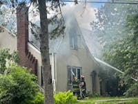 Firefighters put out a house fire in south Minneapolis on the afternoon of May 24. One man who lived at the house died in the blaze.