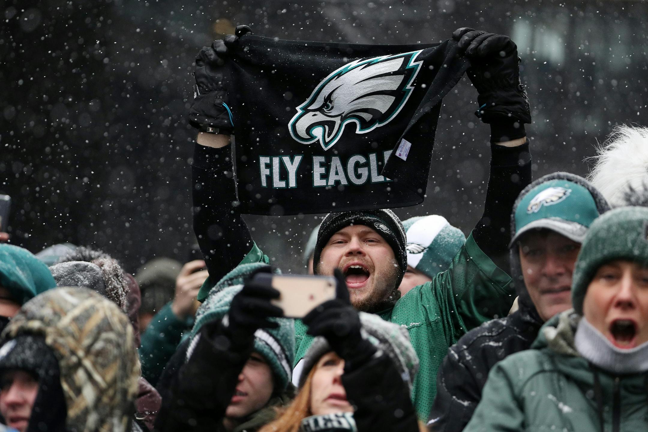 A Philadelphia Eagles fan held up a flag as he cheered during the Eagles rally on Nicollet Mall Saturday.