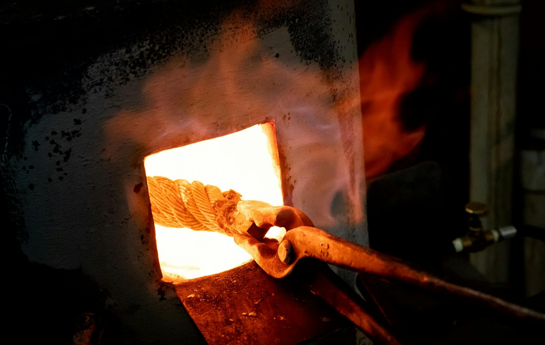 Jason Kraus heated a length of steel cable to 2200 degrees to begin the process of turning it into a knife blade.