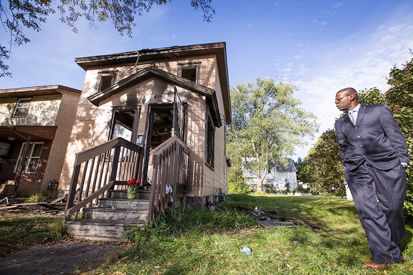 John Martin, a community leader in north Minneapolis, stands at the site of a house fire where three children died on Penn Avenue in north Minneapolis on Sunday, October 4, 2015.