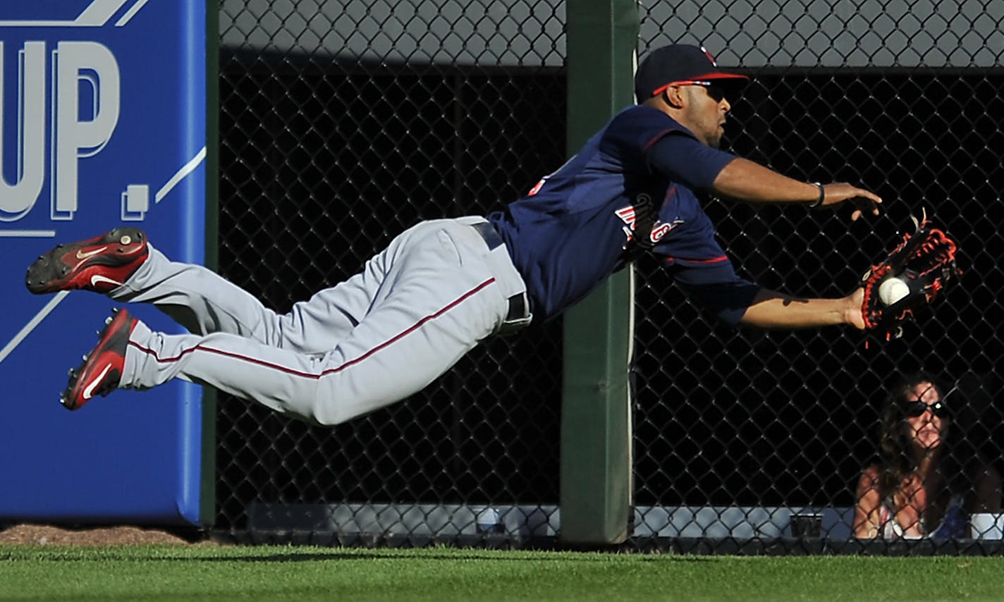 Minnesota Twins center fielder Aaron Hicks (32) catches a fly ball hit by Chicago White Sox's Adam Eaton during the eighth inning of a baseball game Saturday, May 23, 2015, in Chicago. Minnesota won 4-3. (AP Photo/Paul Beaty)