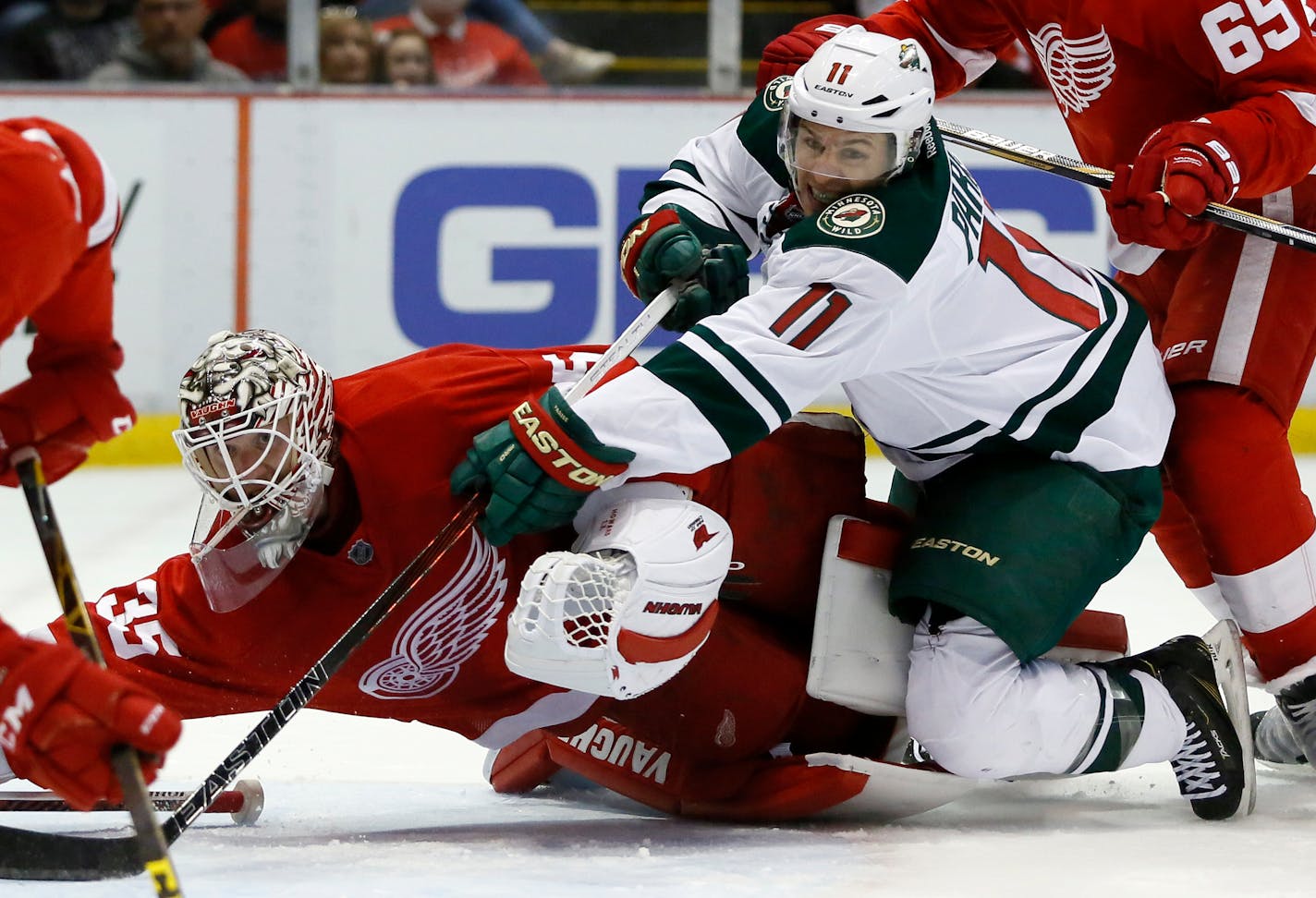 Minnesota Wild's Zach Parise (11) tries to take a shot on goal against Detroit Red Wings' Jimmy Howard (35) during the first period of an NHL hockey game Friday, April 1, 2016, in Detroit. (AP Photo/Duane Burleson)