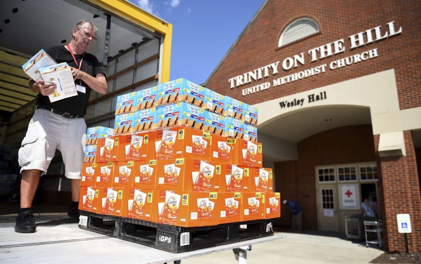 Red Cross volunteer Dennis Cadman packs a pallet of snacks for delivery to Trinity On The Hill United Methodist Church, Tuesday, Sept. 3, 2019 in Augusta, Ga., where Hurricane Dorian evacuees are being sheltered.