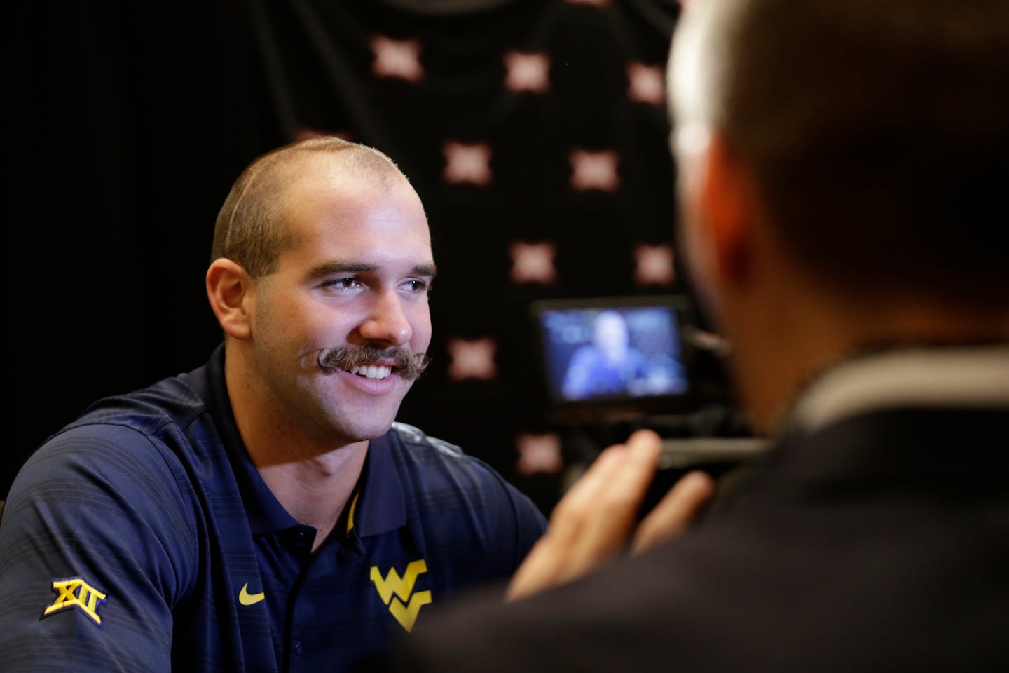 West Virginia punter Nick O'Toole smiles as he speaks reporters during the NCAA college Big 12 Conference football media days in Dallas, Tuesday, July 22, 2014. He grew a long, bushy beard in 2015.