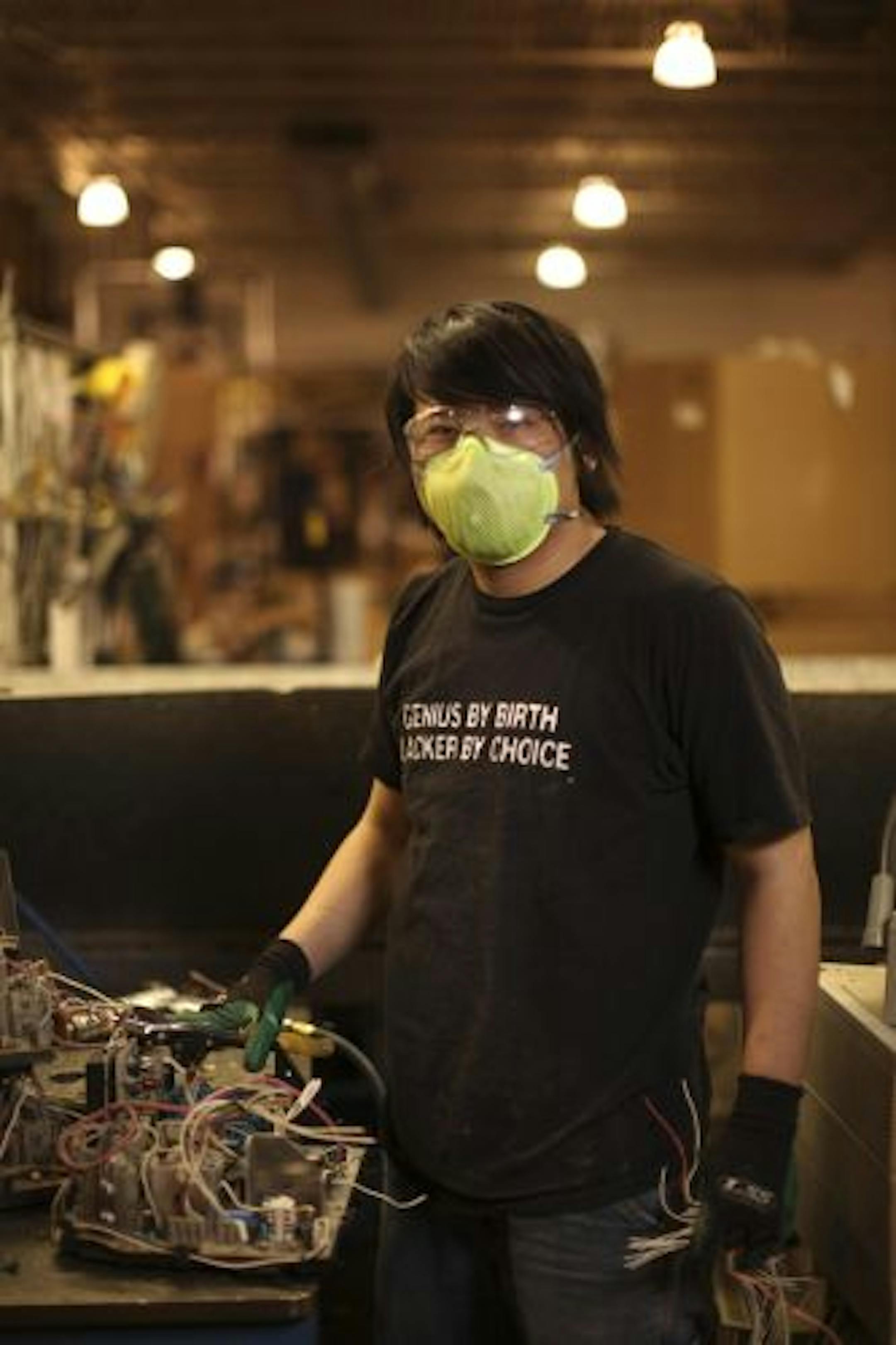 Xiong Vang salvaged wiring from electronic components at MPC Monday afternoon.