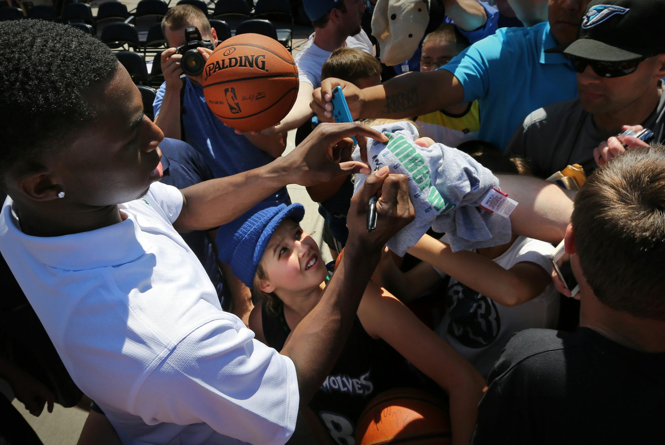 The Timberwolves introduced their new players Anthony Bennett, Andrew Wiggins, Thaddeus Young, Zach LaVine at a Press conference at the State Fair. Here, superfan Annette Lahn, 12, is wsallowed up by the crowd after getting her ball signed by Andrew Wiggins. ] BRIAN PETERSON ‚Ä¢ brian.peterson@startribune.com Falcon Heights, MN 08/26/14