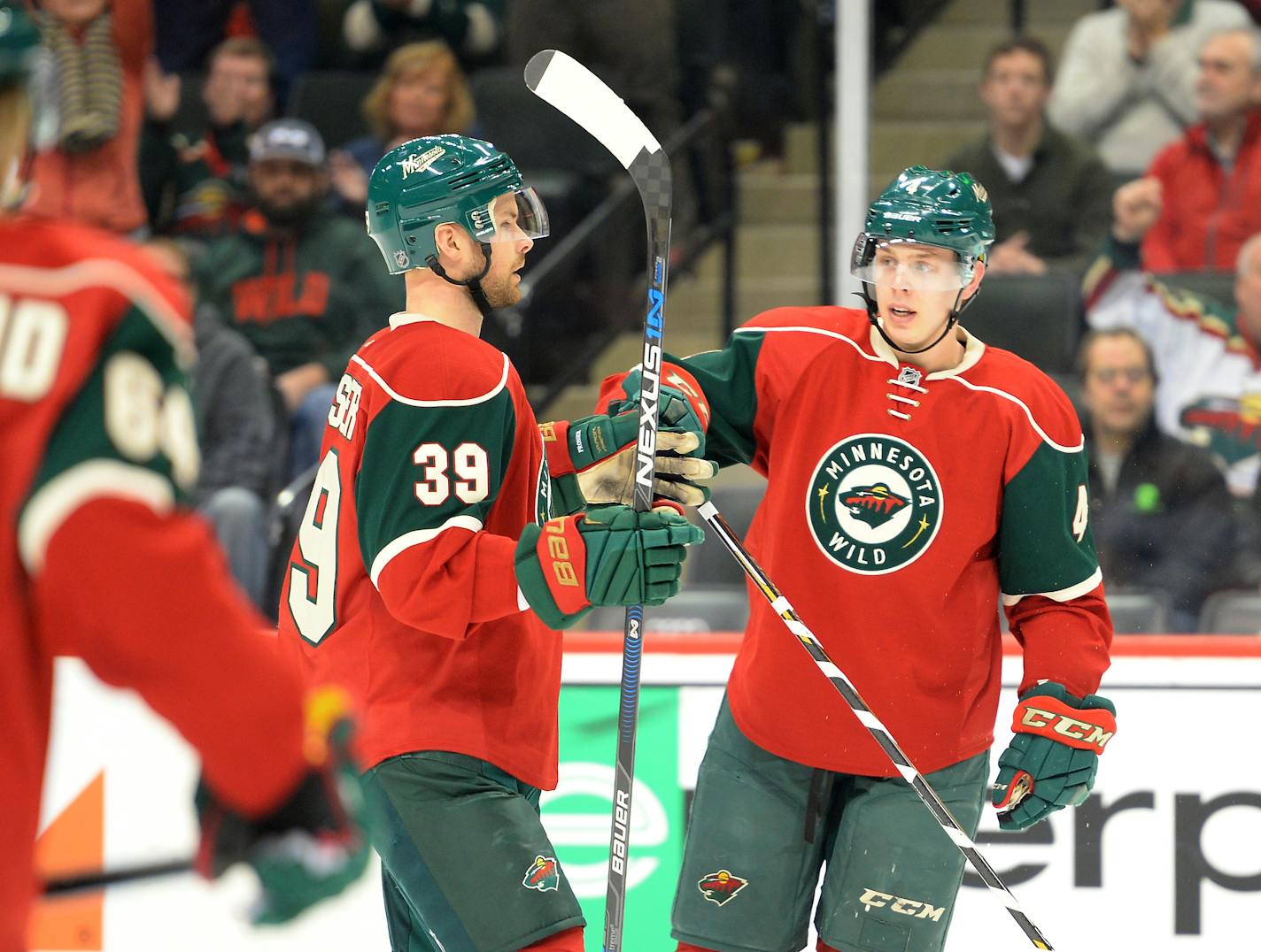 Wild defenseman Nate Prosser (39) and defenseman Mike Reilly celebrated Reilly's first career NHL goal late in the third period against Boston on Saturday.