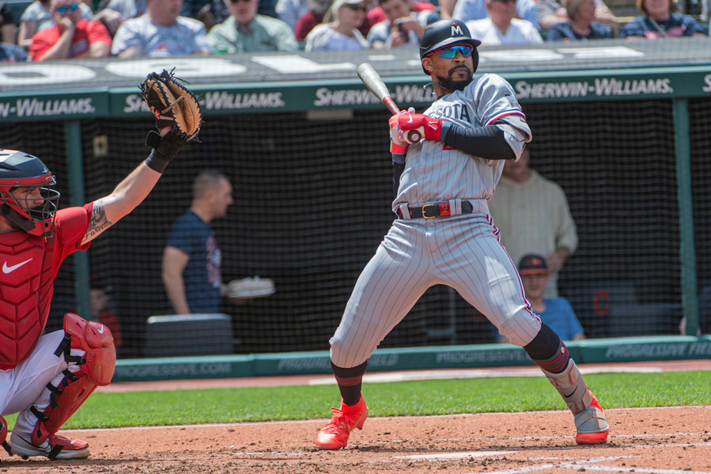 Minnesota Twins' Byron Buxton ducks an inside pitch from Cleveland Guardians starting pitcher Cal Quantrill as catcher Cam Gallagher makes the catch during a baseball game in Cleveland, Sunday, May 7, 2023. (AP Photo/Phil Long)