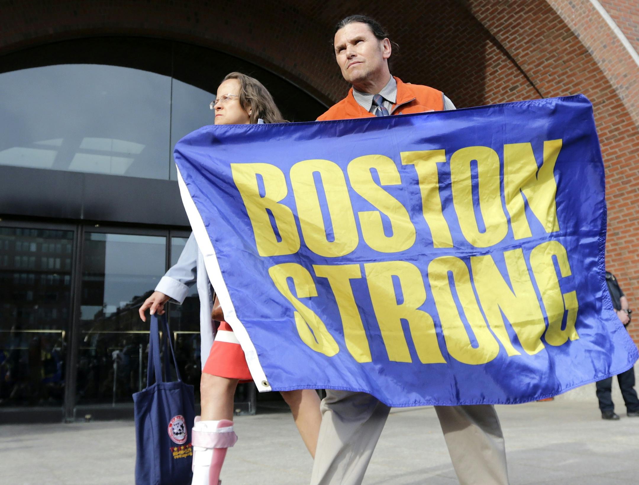 Boston Marathon bombing volunteer first responder Carlos Arredondo holds a "Boston Strong" banner as he leaves the Moakley Federal court with his wife Melida after the verdict in the penalty phase of the trial of Boston Marathon bomber Dzhokhar Tsarnaev, Friday, May 15, 2015. The federal jury ruled that the 21-year-old Tsarnaev should be sentenced to death by lethal injection for his role in the deadly 2013 attack. Carlos is credited with saving the life of bombing survivor Jeff Bauman, who lost