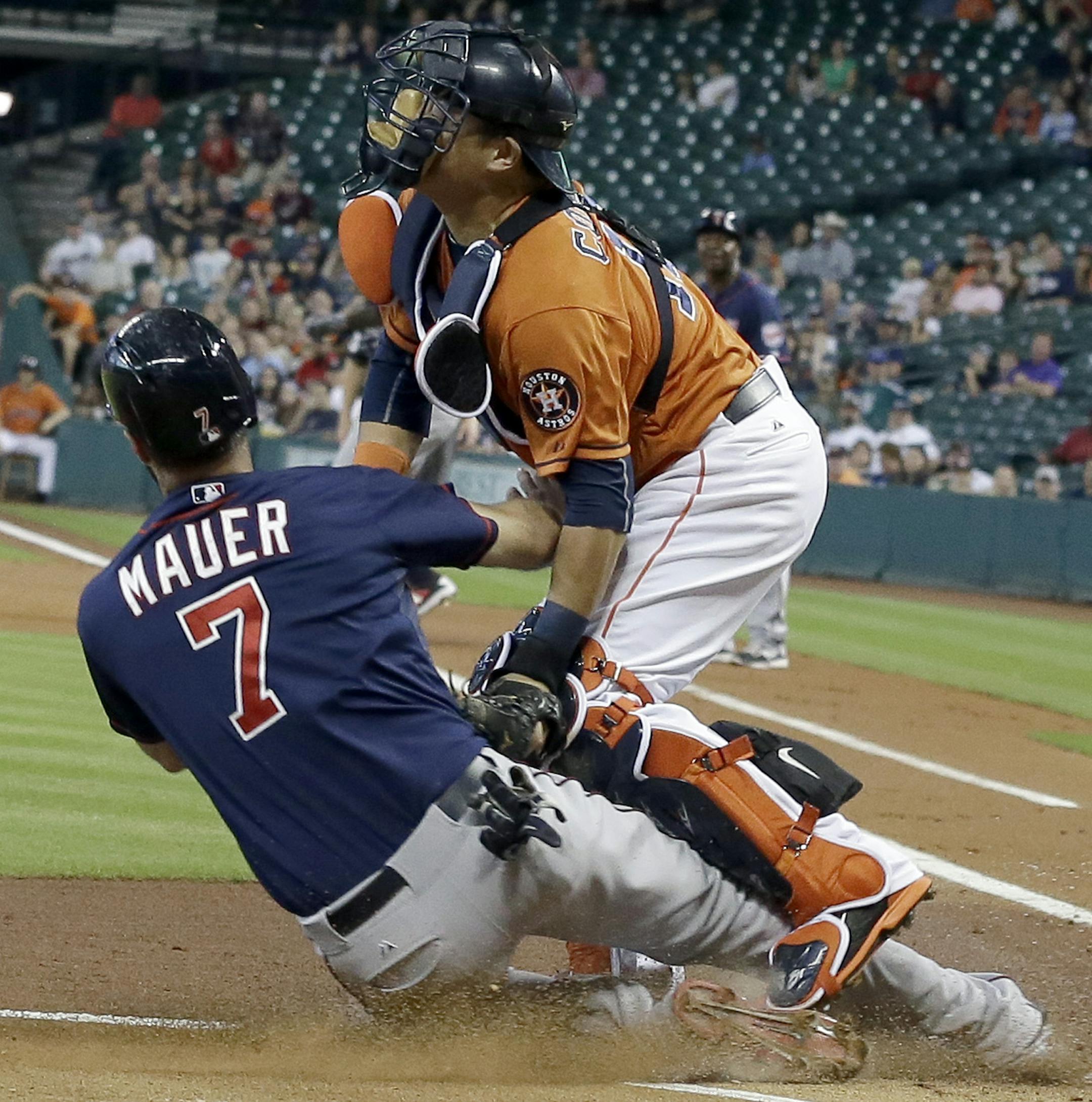 Houston Astros catcher Hank Conger tags out Minnesota Twins' Joe Mauer (7) at home plate as he tried to score from second base on a Miguel Sano single in the first inning of a baseball game Friday, Sept. 4, 2015, in Houston. (AP Photo/Pat Sullivan)