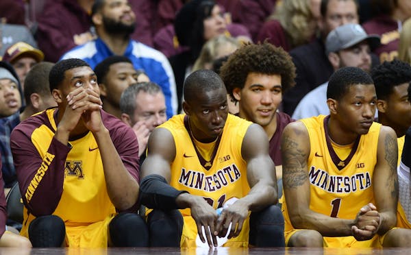 Minnesota Golden Gophers players, including center Bakary Konate (21), center, were dejected on the bench as the Michigan State Spartans extended thei