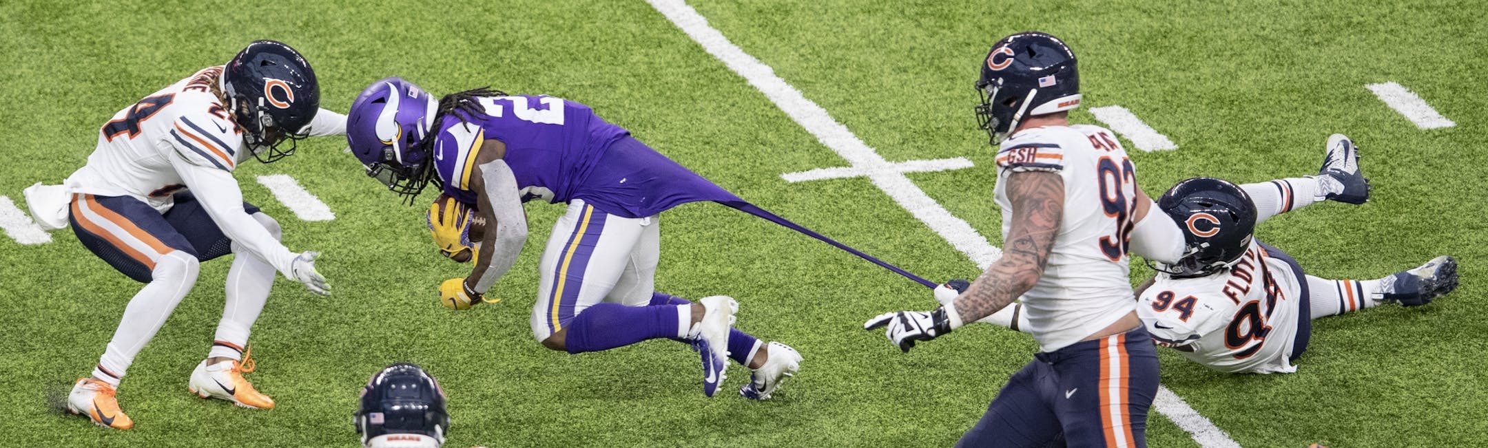 Minnesota Vikings running back Mike Boone (23) was chased down by Chicago Bears' Leonard Floyd (94) in the fourth quarter.