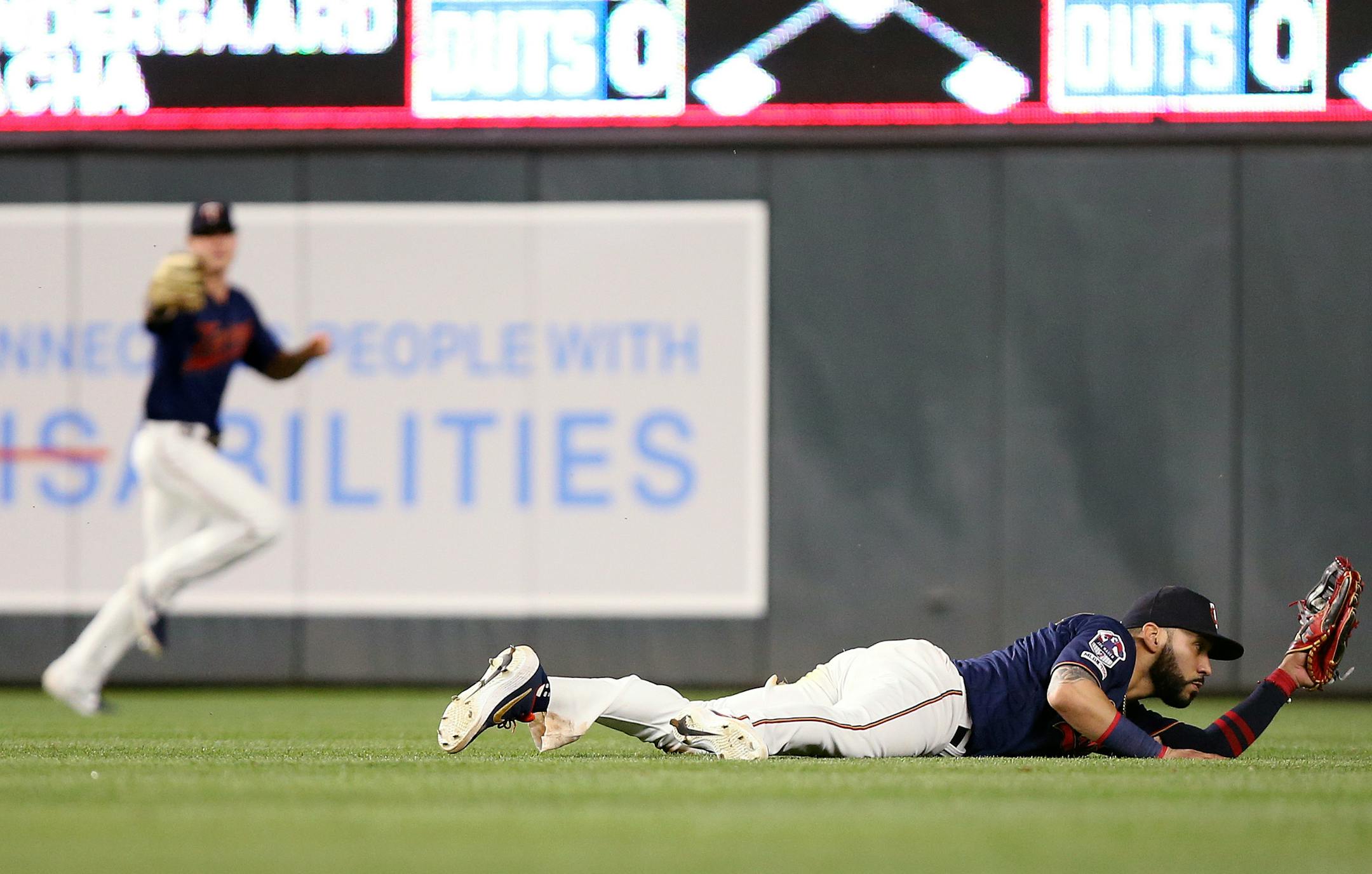 Minnesota Twins' Marwin Gonzalez catches a line drive for an out against Kansas City Royals' Billy Hamilton during the ninth inning of a baseball game Saturday, June 15, 2019, in Minneapolis. (AP Photo/Stacy Bengs)