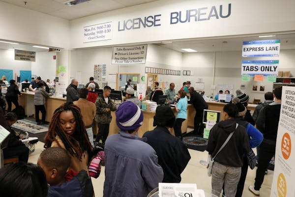 Customers stood in long lines at the department of vehicle services office Friday at the Sears in St. Paul.