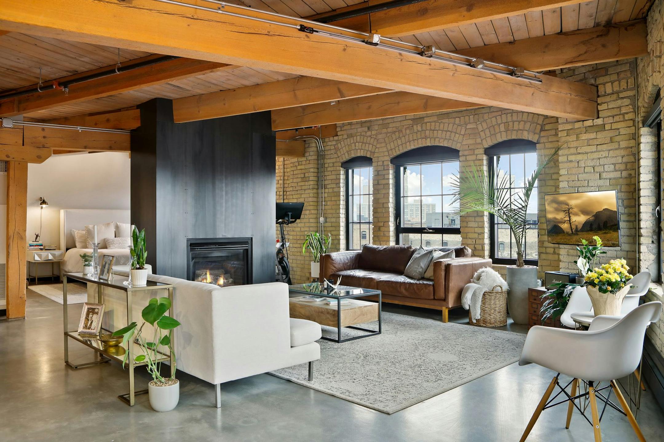 The 1,297-square-foot, one-bedroom unit sits on the sixth floor of a former warehouse, with exposed brick and timber beams.