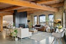 The 1,297-square-foot, one-bedroom unit sits on the sixth floor of a former warehouse, with exposed brick and timber beams.