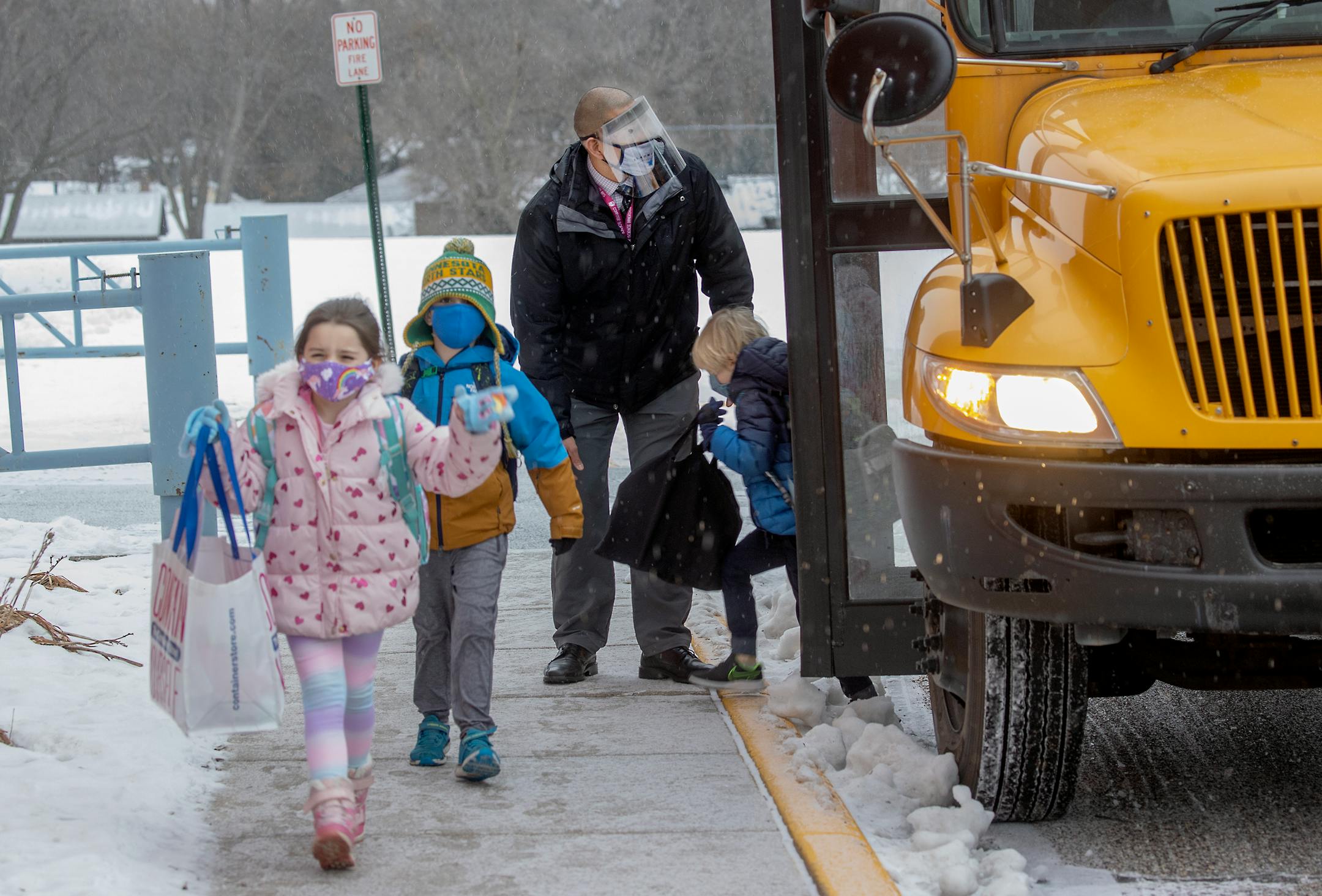 Poplar Elementary School Principal Roberto Cantu welcomed students as they came off the bus for the first day of full in person instruction, Tuesday, January 19, 2021 in Bloomington, MN.