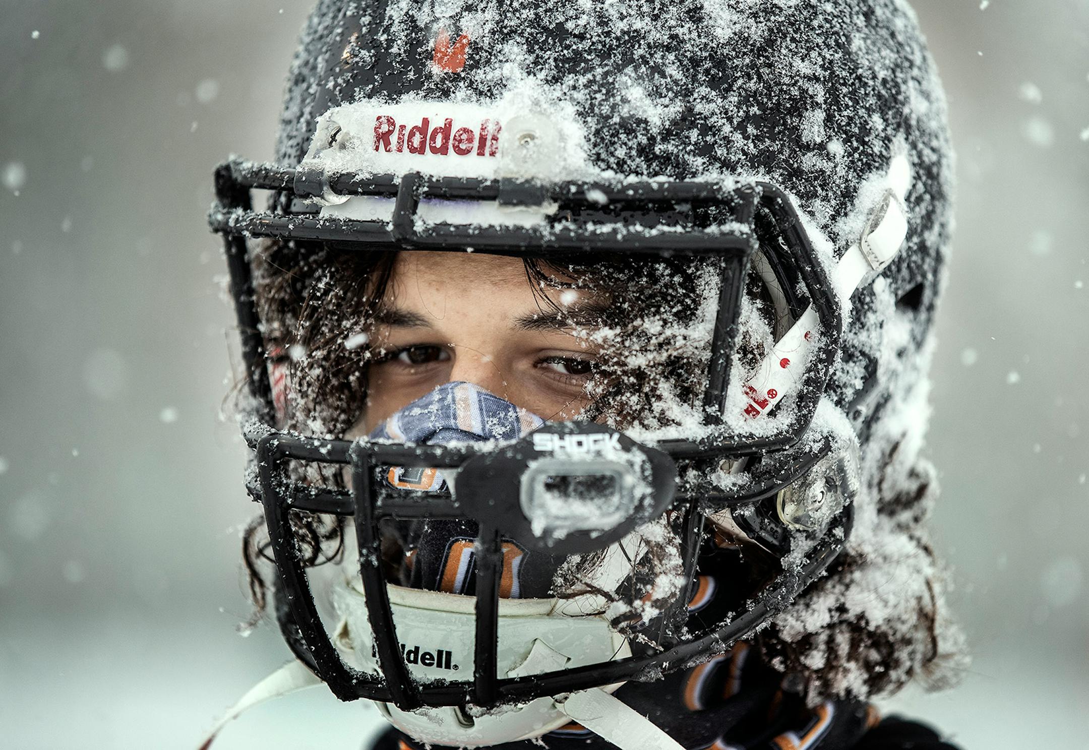 Milton DeJesus and members of the Osseo football team practiced outside in the heavy snow in preparation for their Friday night game against Totino-Grace.