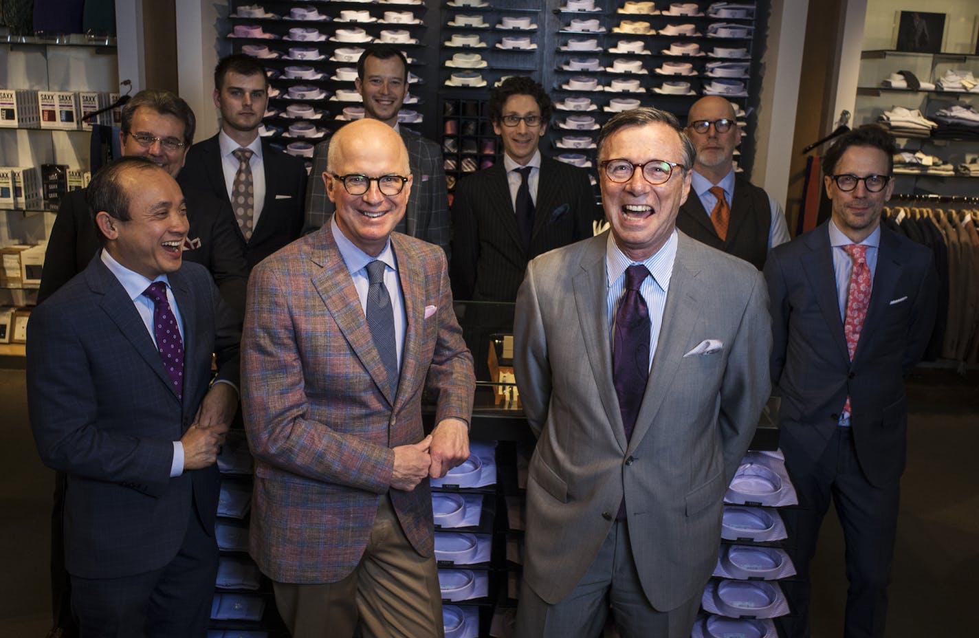 Hubert White general manager Brad Sherman, center left; president Bob White, center right, and other staff members, at the store in Minneapolis&#x2019; IDS Center.