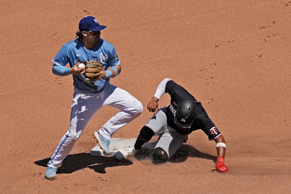 Kansas City Royals shortstop Bobby Witt Jr. forces out Willi Castro at second base in the seventh inning.