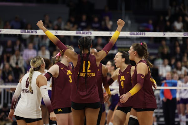 Taylor Landfair (12) circled her teammates around her during the Gophers’ four-set win over Northwestern on Sunday. Landfair led the way by posting 