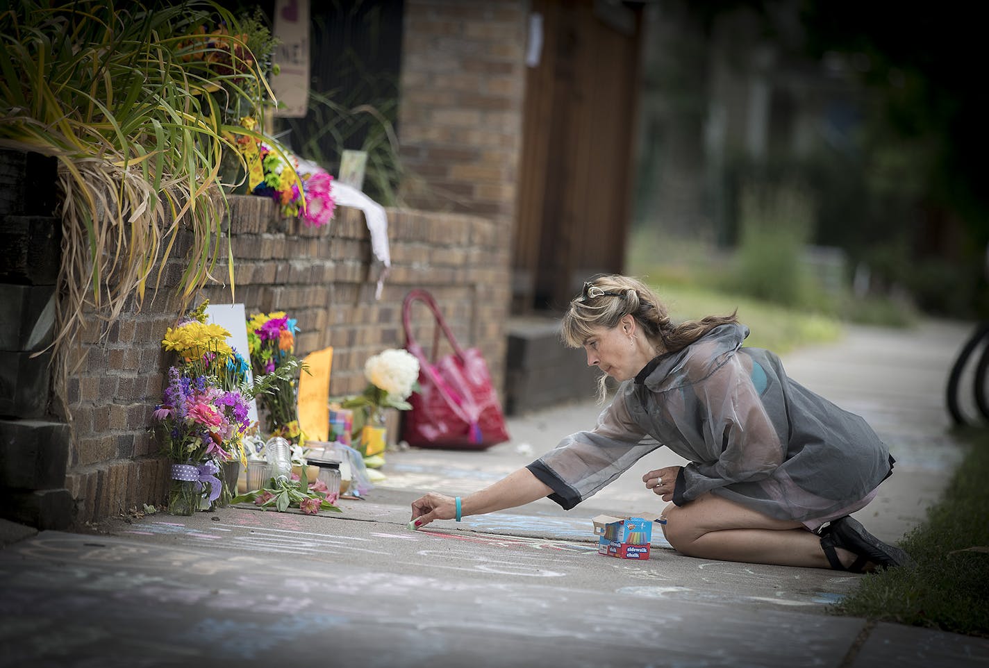 Megan O'Leary of St. Paul left a message on the sidewalk near the scene where a Minneapolis police officer shot and killed Justine Damond, Monday, July 17, 2017 in Minneapolis.