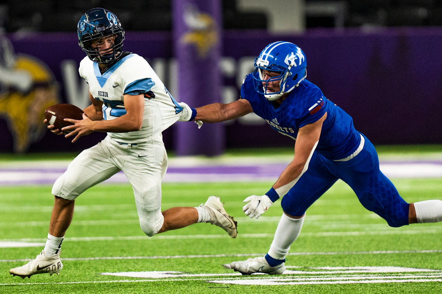 Kasson-Mantorville's Gavin Keisler tackles Ryan Bengston for a loss.