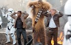 "Star Wars: The Force Awakens" stars, from left, John Boyega as Finn, Peter Mayhew as Chewbacca and Harrison Ford as Han Solo.