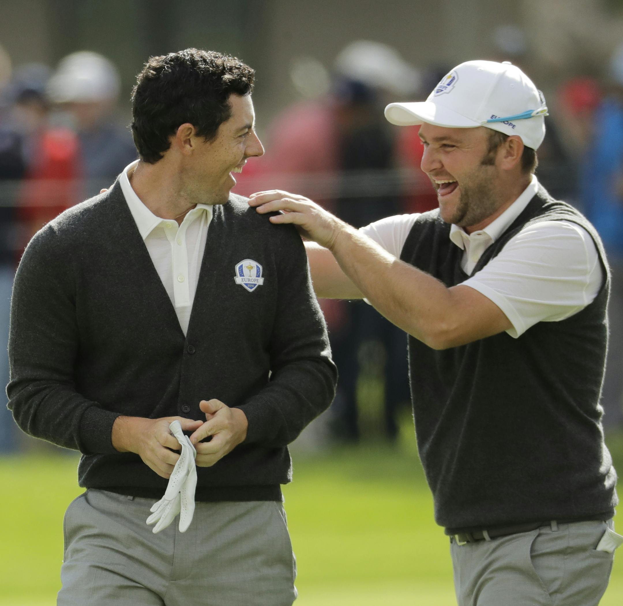 Europe's Andy Sullivan congratulates Europe's Rory McIlroy after McIlroy holed his approach shot on the sixth hole during a practice round for the Ryder Cup golf tournament Thursday, Sept. 29, 2016, at Hazeltine National Golf Club in Chaska, Minn. (AP Photo/Charlie Riedel)