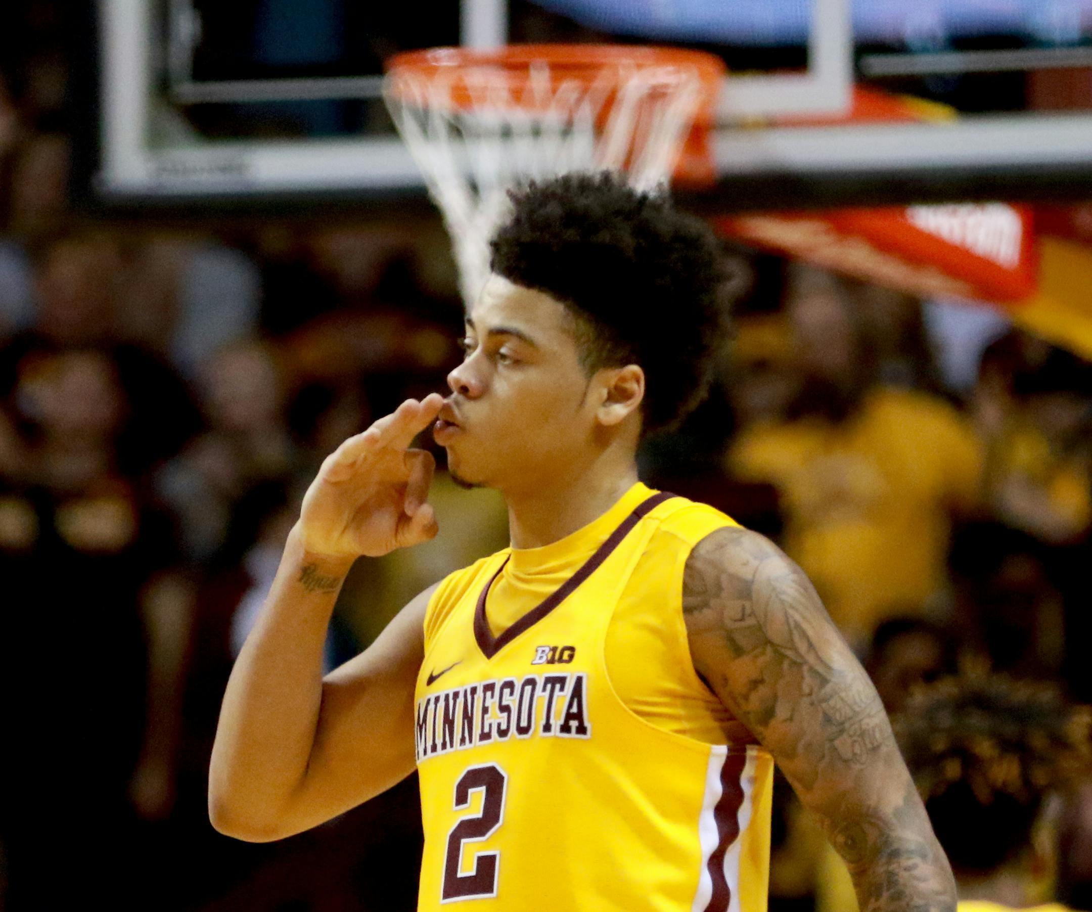 Nate Mason signals three after knocking one down against Penn State in the first half Saturday