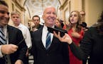House Ways and Means Committee Chairman Kevin Brady, R-Texas, is pursued by reporters in the Capitol after signing the conference committee report to 