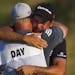 Jason Day hugs his caddie, Colin Swatton, after making par on the 18th hole and winning the 2015 PGA Championship on Sunday, Aug. 16, 2015, at Whistli