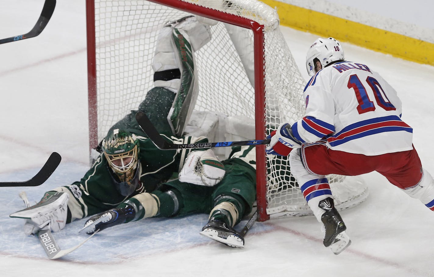 New York Rangers&#x2019; J.T. Miller, right, looked for a rebound while Wild goalie Devan Dubnyk, with the assistance of Jared Spurgeon, smothered a shot Saturday. Dubnyk has a .899 save percentage during the Wild&#x2019;s 10-game swoon.