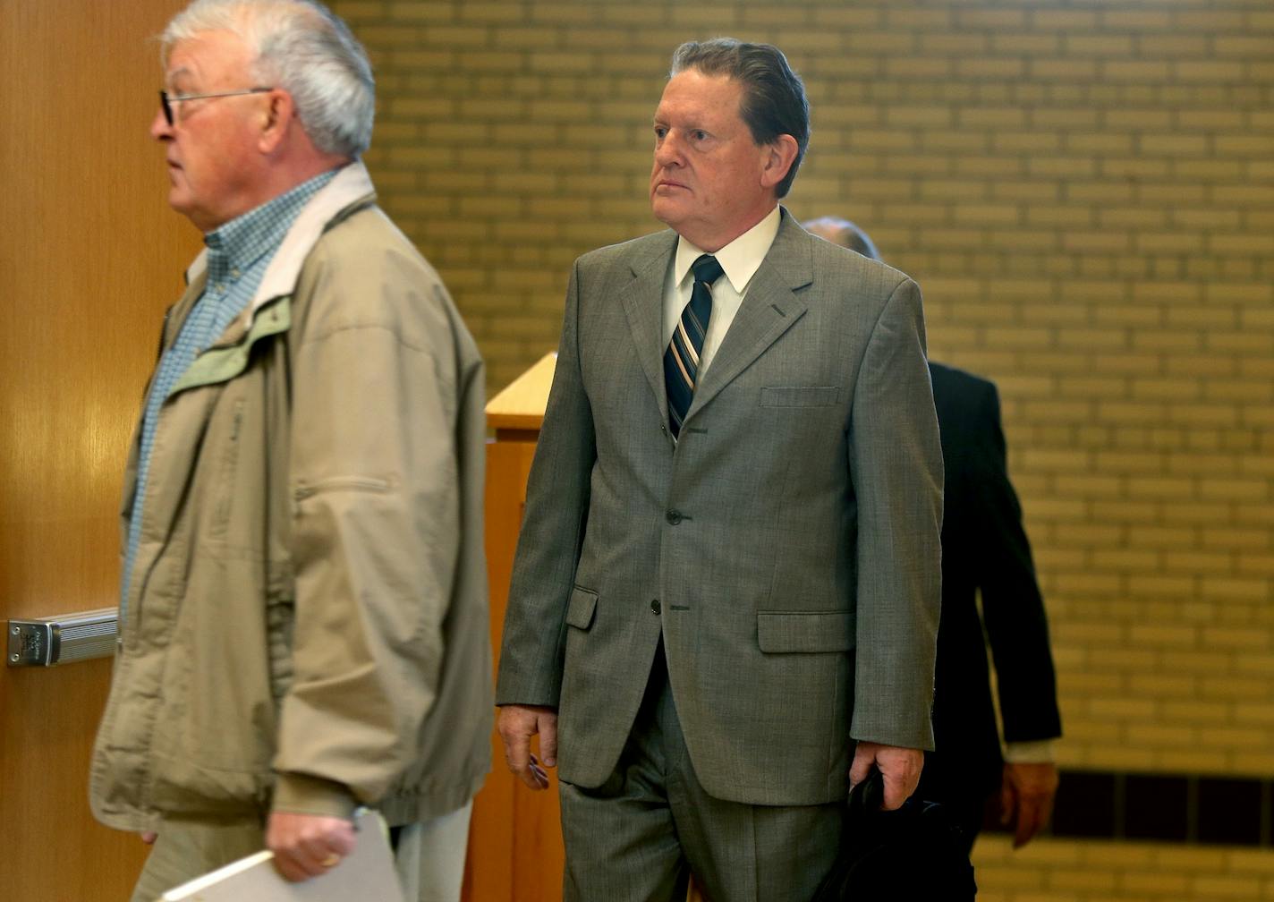 Byron Smith, right, made his way through security at the Morrison County Courthouse, Monday, April 21, 2014, in Little Falls, Minn.