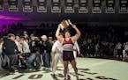 Tyler Kim holds up the "Swens-Milboy Belt," awarded to the winner of the Augsburg-Wartburg men's wrestling dual meet, after his win at 285 pounds clin