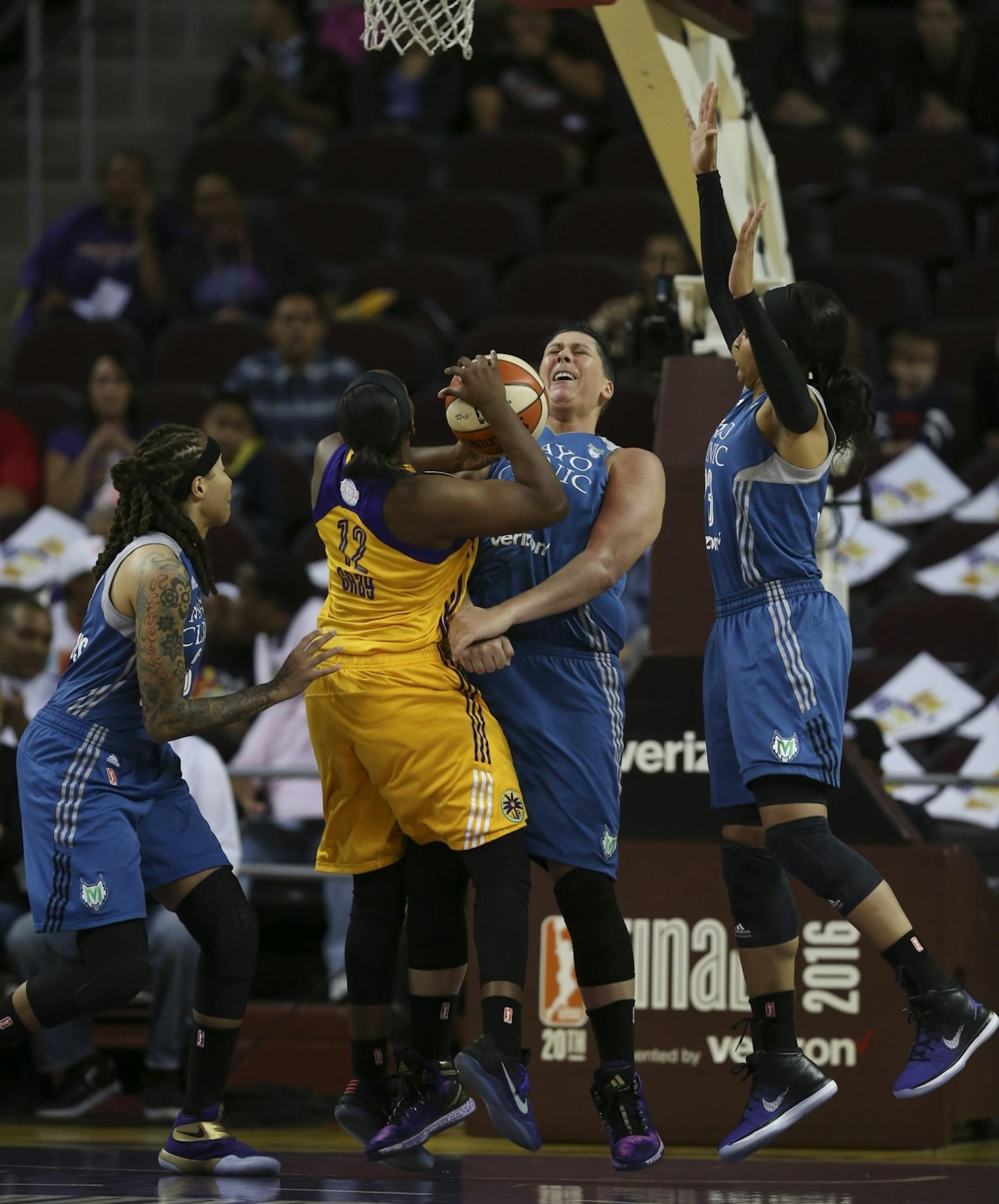 Minnesota Lynx center Janel McCarville (4) fouled \s32\ as she drove to the net in the second quarter.