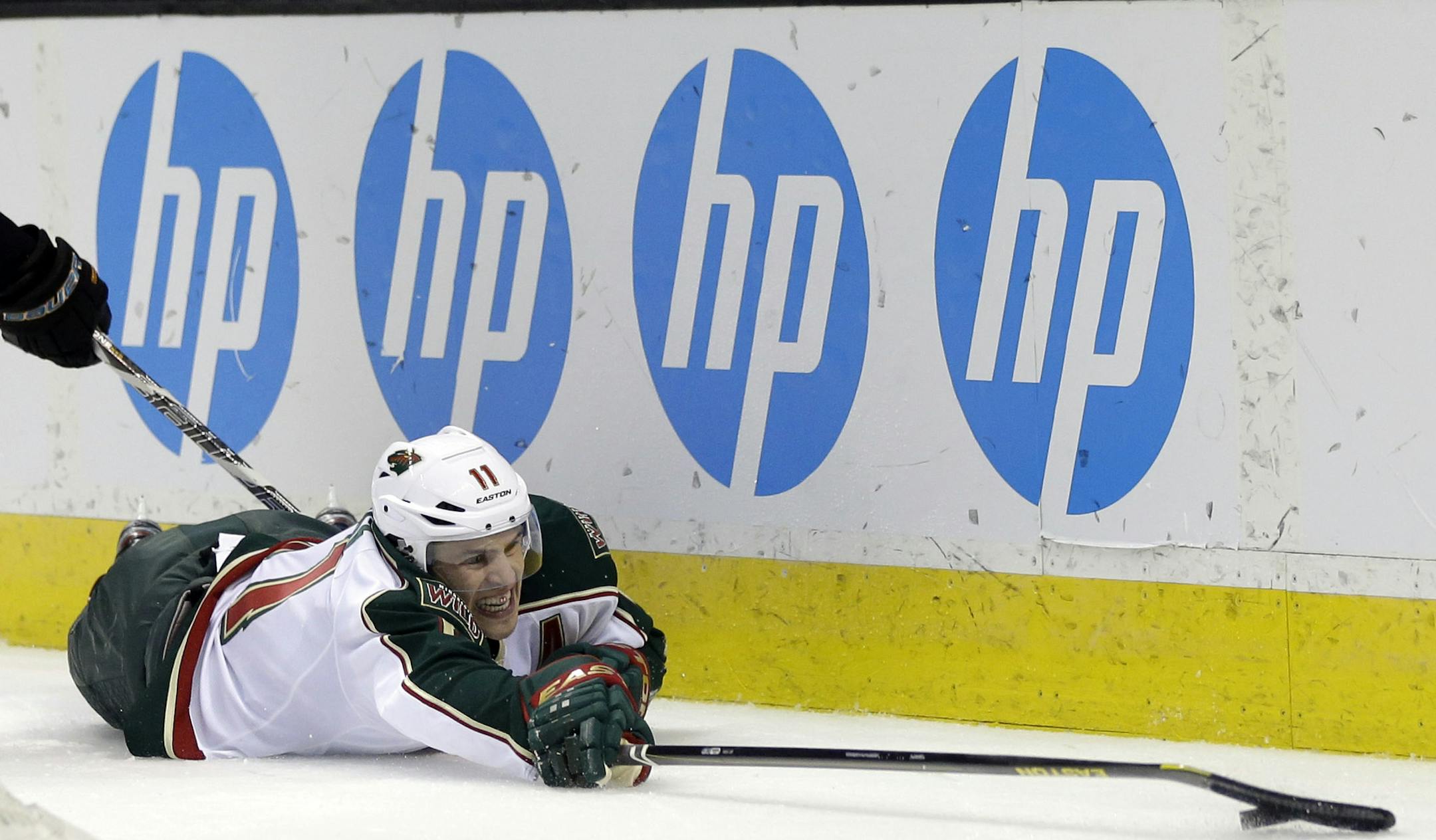 Minnesota Wild left wing Zach Parise (11) lunges for the puck against the San Jose Sharks during the second period of an NHL hockey game in San Jose, Calif., Thursday, April 18, 2013. (AP Photo/Marcio Jose Sanchez)