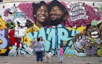 Bryan Esparaza and her daughter Amelia, 4, pause in front of a mural put up of Kobe Bryant and his daughter along Pickford Street in Los Angeles, Mond