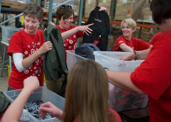 Volunteers from Target packed school items into backpacks at Kids in Need in 2014. 