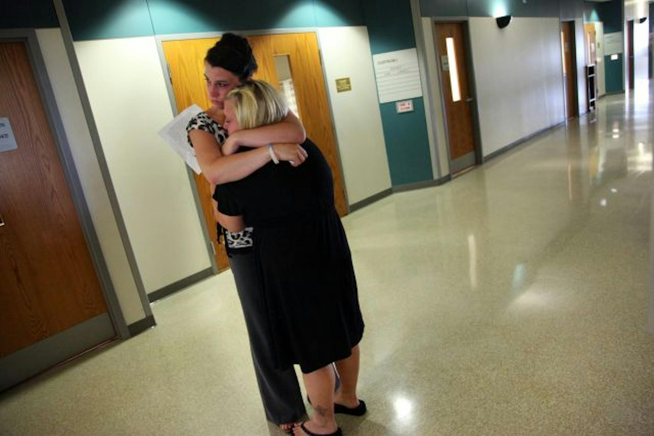 Marni Privratsky, left, and Krysta Howes, friends of Kelly Dahm, hugged Monday outside the Hudson, Wis., courtroom where Christopher Ledesma pleaded guilty to Dahm's murder last fall and was sentenced to 35 years in prison.