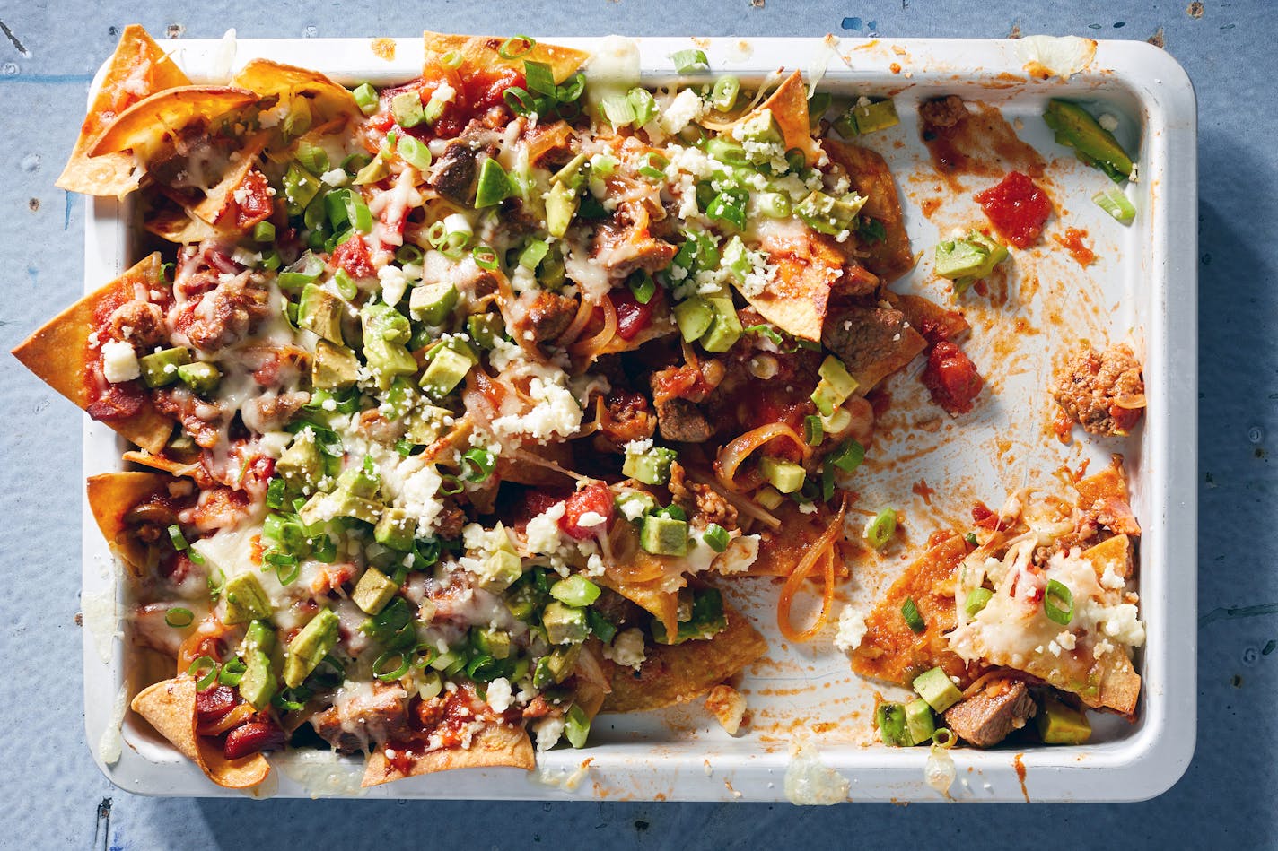 Bricklayer-style Nachos, a sheet pan recipe. Food stylist: Simon Andrews. (Christopher Simpson/The New York Times)