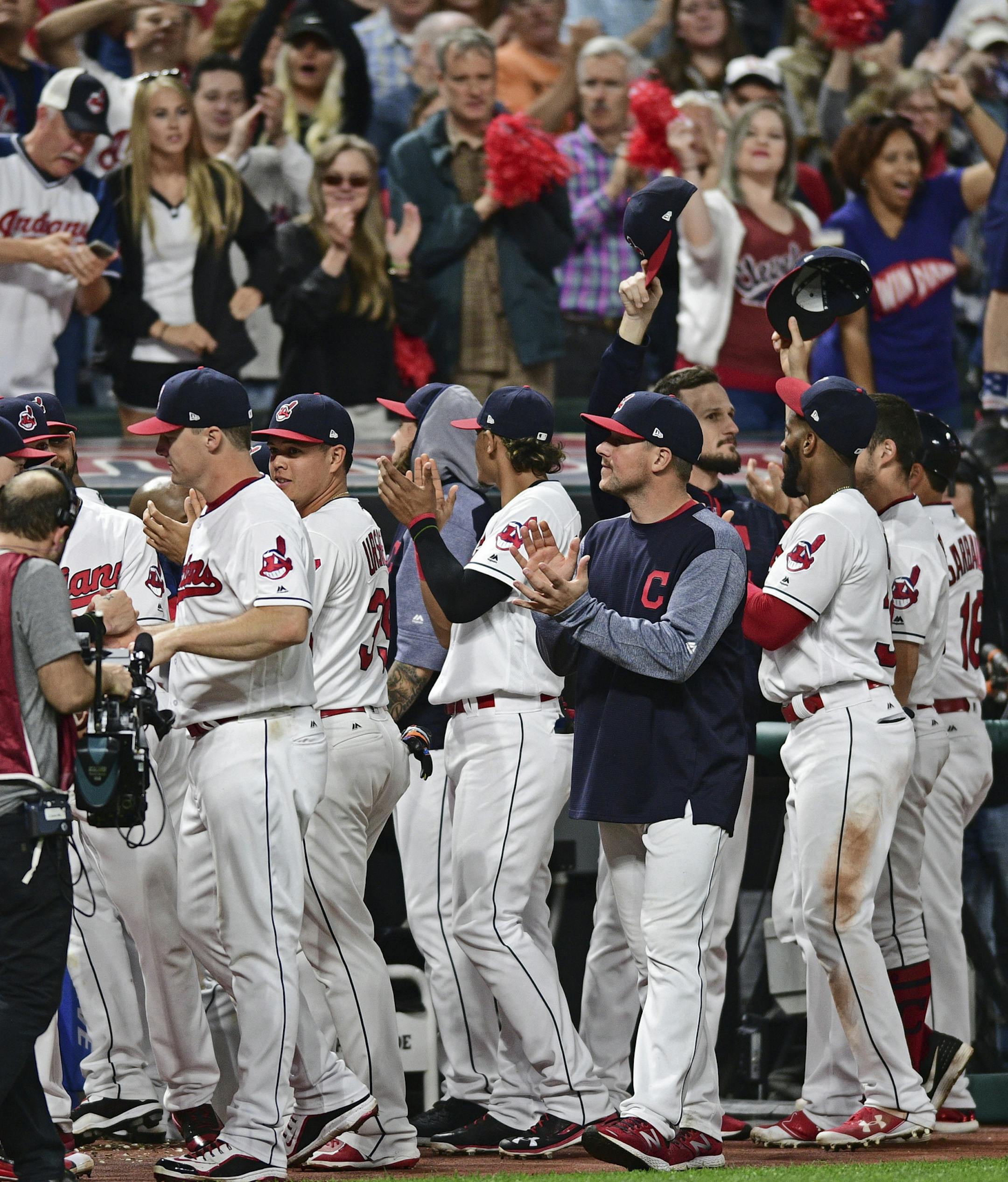 Cleveland Indians fans applaud the fans after the ninth inning of a baseball game against the Kansas City Royals, Friday, Sept. 15, 2017, in Cleveland. (AP Photo/David Dermer)