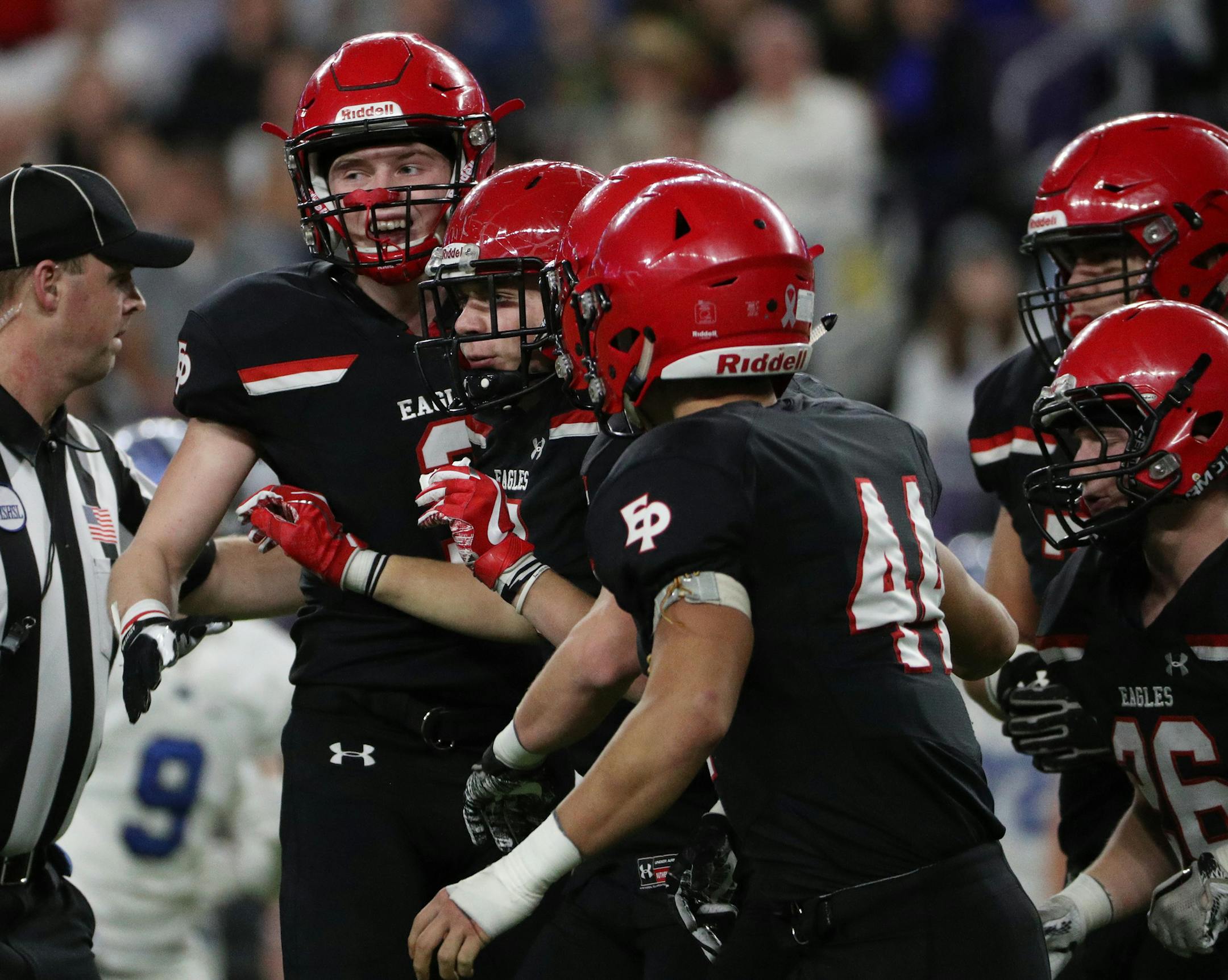 Eden Prairie High School defensive back Kyler Kluge (7) was mobbed by his teammates after making an interception in the first half. ] ANTHONY SOUFFLE ï anthony.souffle@startribune.com Game action from a Class 6A championship football game between Eden Prairie High School and Minnetonka High School Friday, Nov. 24, 2017 at U.S. Bank Stadium in Minneapolis.