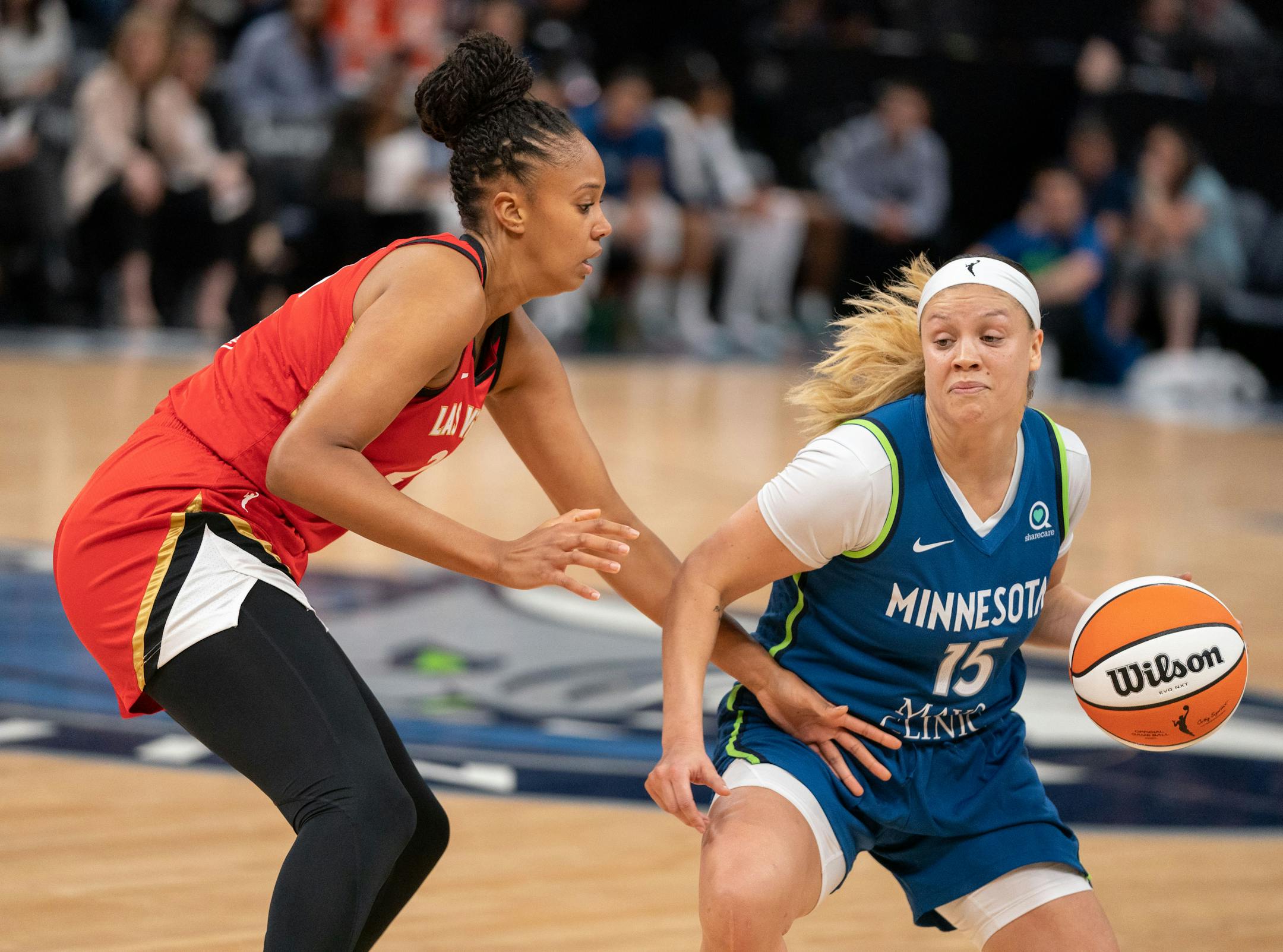 Minnesota Lynx guard Rachel Banham (15) dribbles the ball down the court while Las Vegas Aces center Iliana Rupert (21) blocks during the first half of the game.