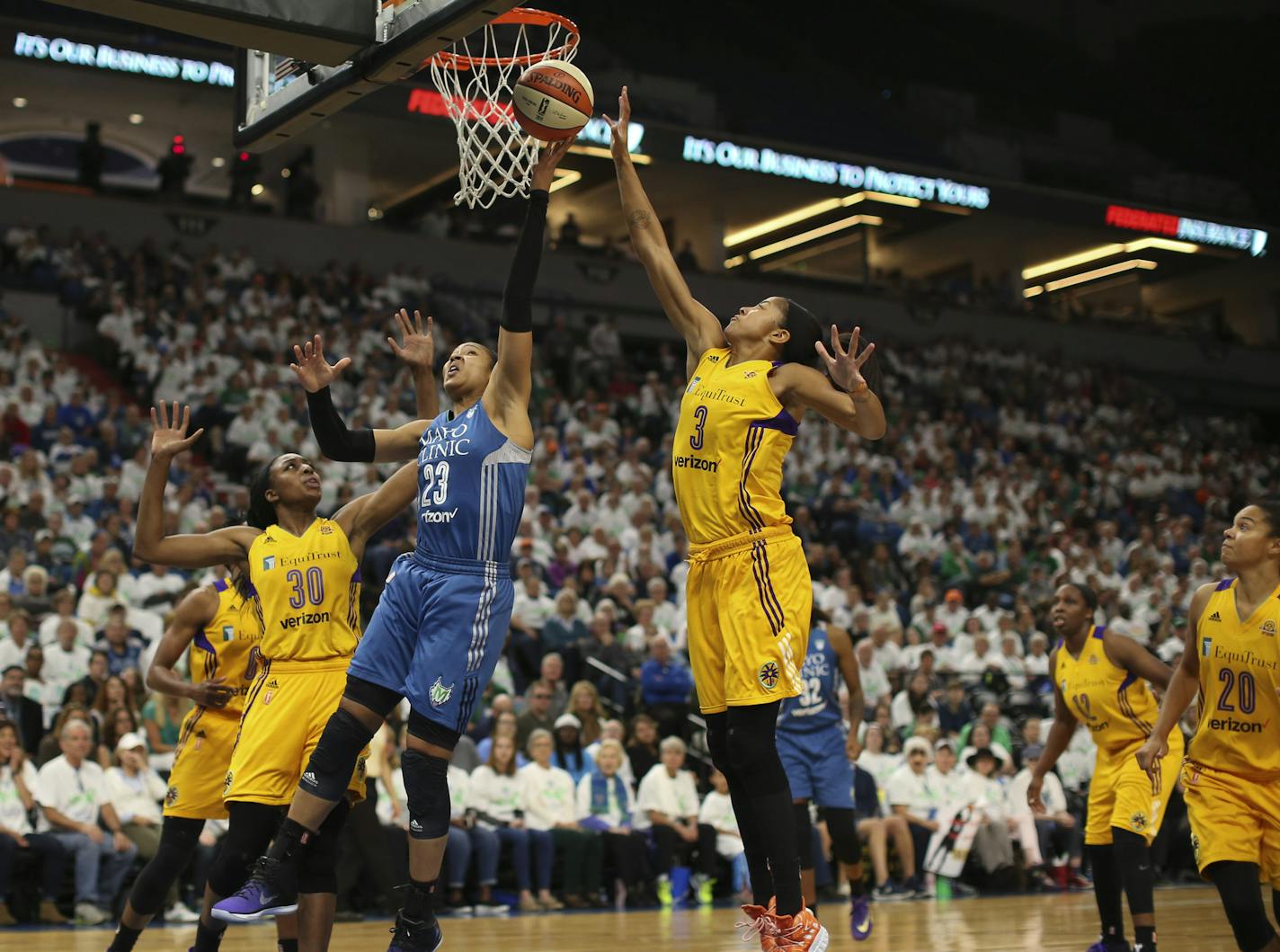 Lynx forward Maya Moore (23) shot between the defense of Sparks forwards Nneka Ogwumike (30) and Candace Parker (3). Moore finished with 18 points.